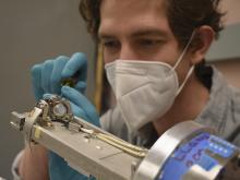 Photo of Aaron Rosenthal, masked, working on diagnostic